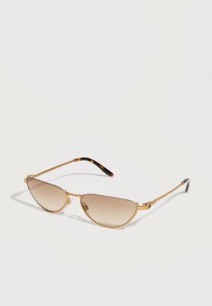Slim gold metal-frame sunglasses with brown gradient lenses and tortoiseshell-patterned temple tips on white background.