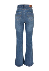 Flared blue jeans made of denim with a medium wash. Features two back pockets and a leather patch on the waistband for branding.