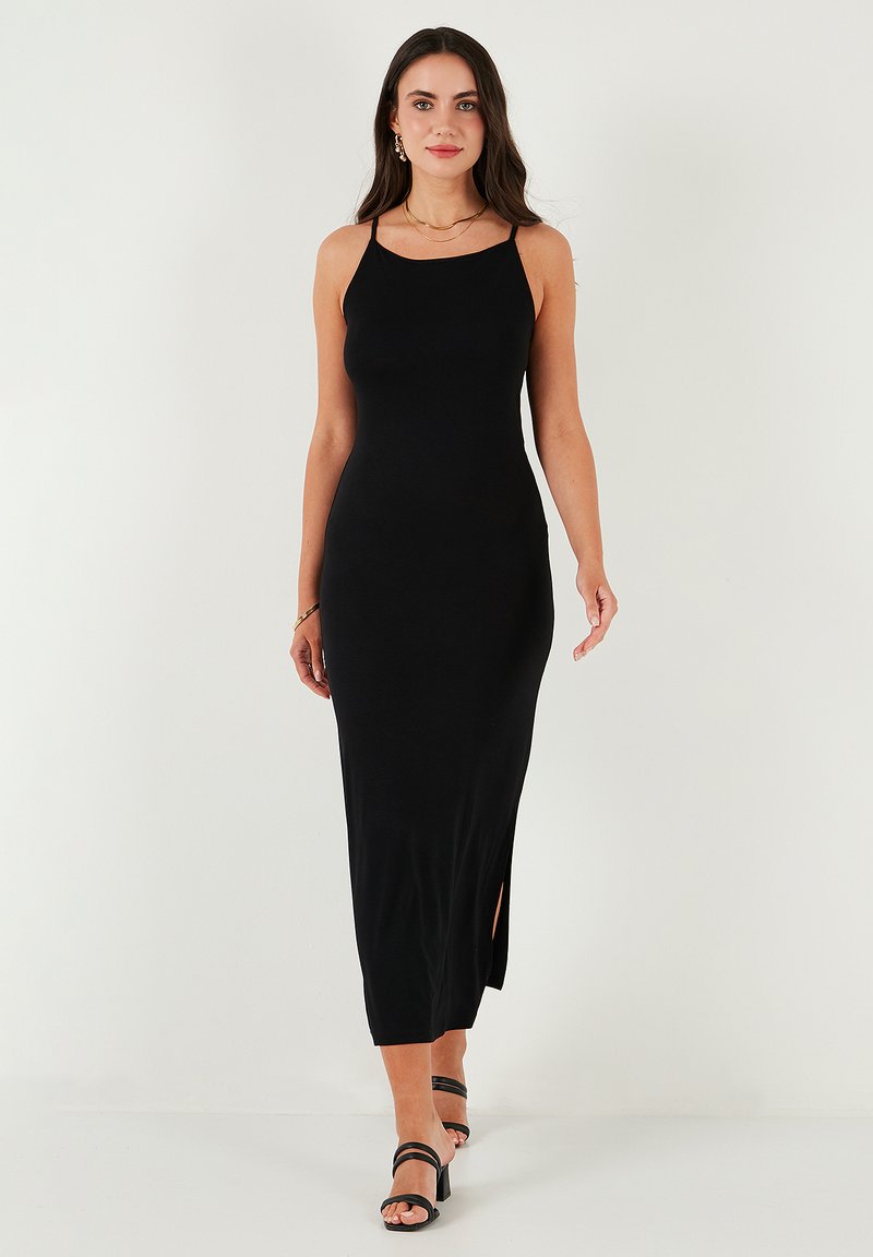 Black, sleeveless maxi dress with a fitted silhouette and side slit. Smooth texture with adjustable straps and a classic neckline.