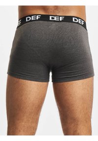 Gray cotton boxer briefs with a black elastic waistband featuring white "DEF" branding; smooth texture and fitted design with short legs.