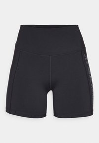 Pantaloni sportivi neri realizzati in tessuto elasticizzato, con vita alta e dettaglio del logo laterale. Texture liscia con cuciture piatte.