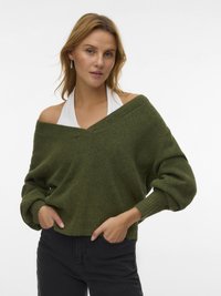 Green oversized sweater in soft knit, featuring off-shoulder design, ribbed cuffs, and a cropped hem. Paired with black pants.