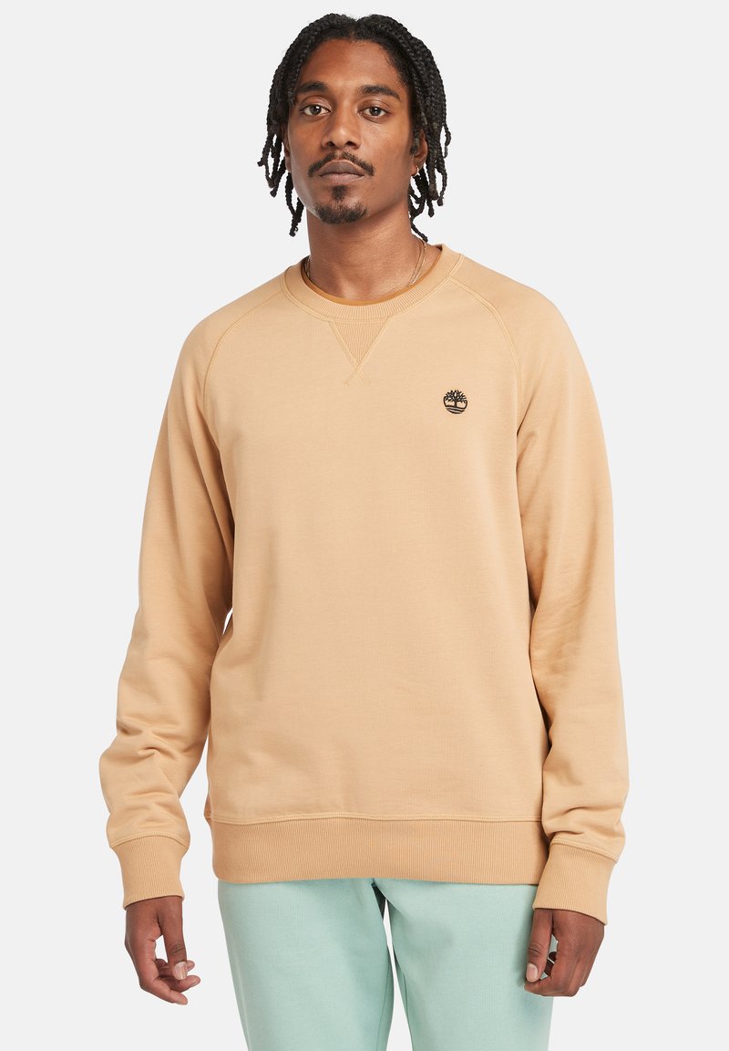 Beige sweatshirts med ribbede manchetter og kant, prydet med et lille sort logo på brystet, lavet af blødt og komfortabelt stof.