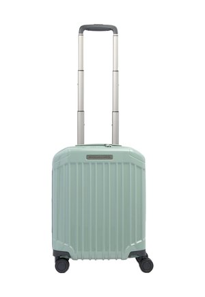 Valise à coque dure vert clair avec des rainures verticales, quatre roues et une poignée télescopique extensible.