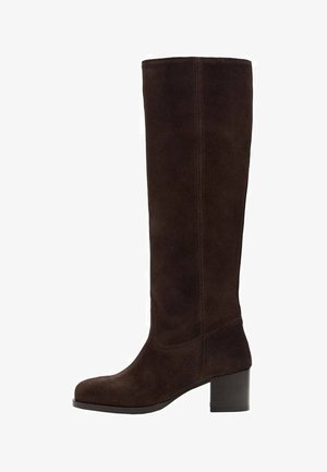 Brązowy zamszowy kozak do kolan z kwadratowym noskiem, obcasem typu słupek i pionowym przeszyciem. Miękka faktura i gładki wygląd.