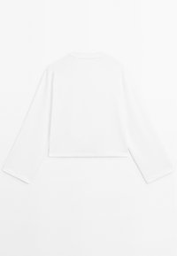 White cropped long-sleeve top with a round neckline, featuring a smooth texture and clean, simple design, without any visible patterns or embellishments.