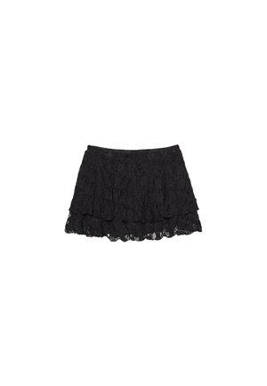 Black lace skirt with a layered design, featuring a textured surface and scalloped hem. Elastic waistband for comfortable fit.
