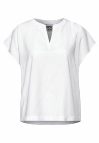 Top in cotone bianco con scollo a V e maniche corte e larghe. Design semplice con una vestibilità rilassata e senza motivi o accenti visibili.
