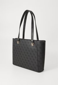 Black tote bag with a textured surface, featuring a monogram pattern. It has two long handles and gold-tone hardware accents.