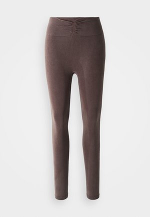 High-waisted brown ribbed leggings with gathered detail on the waistband, displayed on a white background.