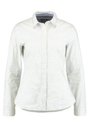 Wit overhemd met lange mouwen, kleine zwarte polkadots, een puntige kraag en een licht gebogen zoom.