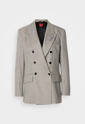 Kahekordse nööpimisega jakk ruudulise mustriga beezhi, musta ja sinise toonides. Omadused: teravate kraeotsadega (peak lapels) jakk, kaks esitaskut ja mustad nööbid.