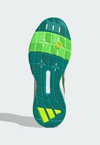 Shoe sole with a textured pattern, predominantly turquoise and bright green detailing, featuring a circular yellow component and three stripes.