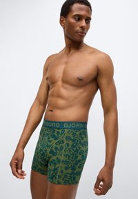 Πράσινα μποξεράκια με σχέδιο φύλλων, ελαστική μέση με την ετικέτα "BJÖRN BORG", με εφαρμοστή σχεδίαση και απαλή υφή υφάσματος.