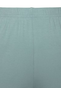 Jasnoniebieskie legginsy z elastycznym paskiem w talii, wykonane z gładkiego, lekko teksturowanego materiału, bez widocznych wzorów czy akcentów.