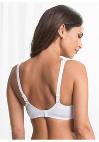 Bra bianco con spalline regolabili e chiusura a gancio. Tessuto liscio con dettagli in pizzo lungo i bordi delle spalline. Presenta un design senza cuciture.