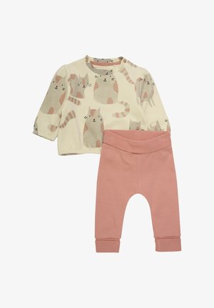 Two-piece children's outfit featuring a cream long-sleeve top with a cat pattern and pink cotton leggings with ankle cuffs.