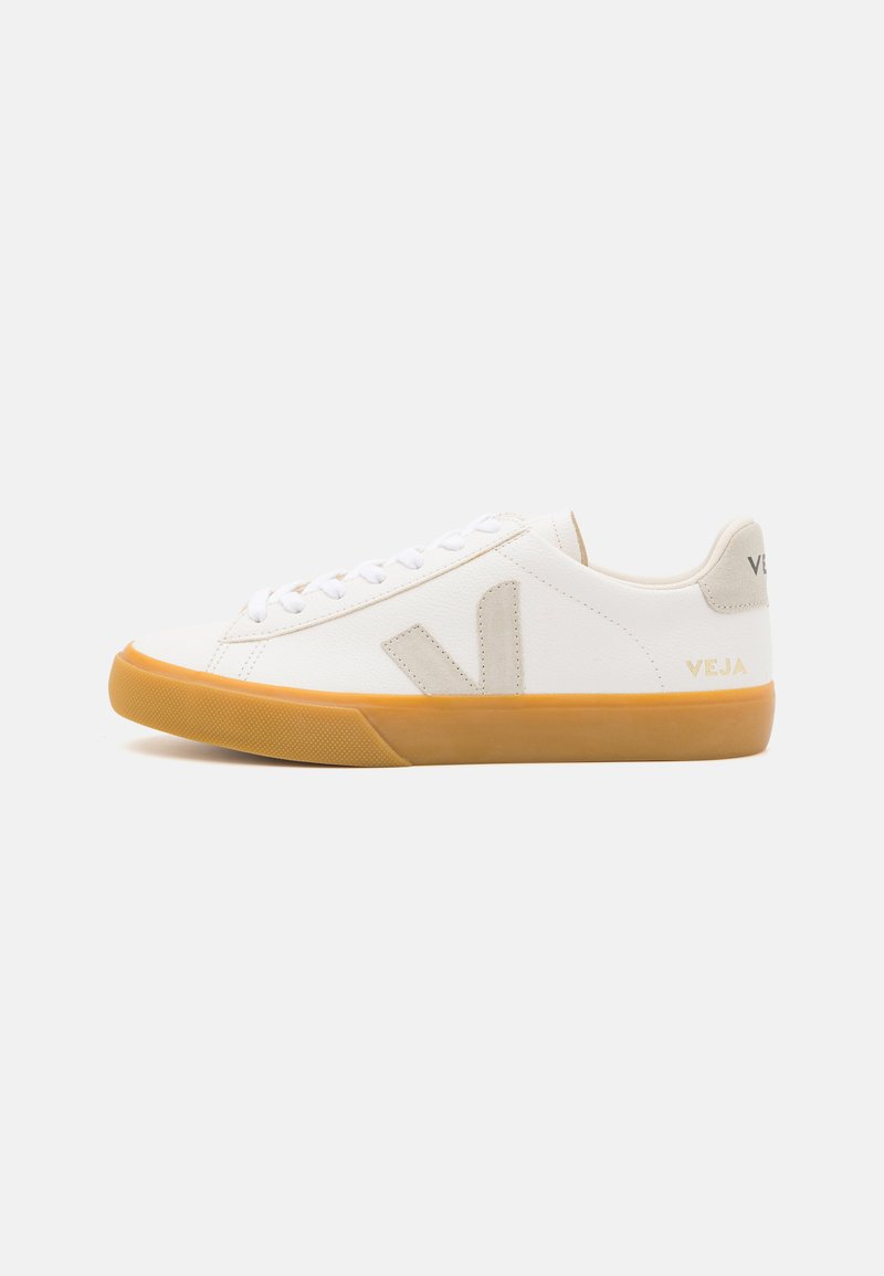 White leather sneakers with a beige "V" logo, round toe, lace-up front, and gum rubber sole. Minimalist design with soft texture.