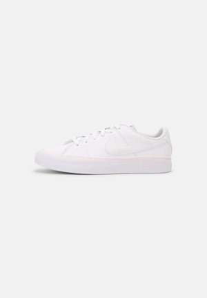Low-profile white Nike sneaker with lace-up closure, rubber sole, and embroidered swoosh logo on side, shown in side view on white background.