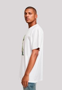 White short-sleeve t-shirt featuring a colorful graphic design. Soft cotton fabric, relaxed fit, minimalistic style, and a crew neckline.