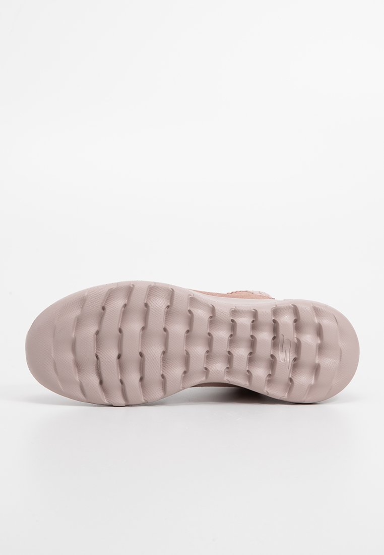 Helle rosa Sportschuhsohle mit strukturiertem Gummi für Grip, ausgestattet mit einer glatten Oberfläche und konturiertem Design für Komfort.