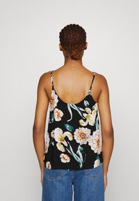 Black floral camisole with spaghetti straps, featuring large orange and white flowers, green leaves, and a relaxed fit.