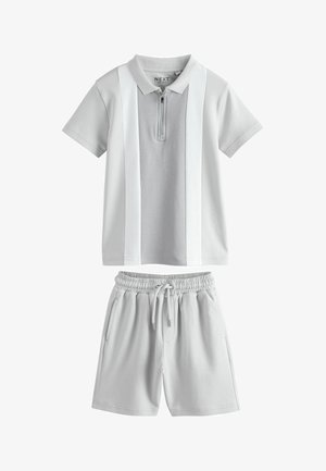 Short-sleeve gray polo with front zipper and vertical white stripes paired with light gray elastic waist drawstring shorts.