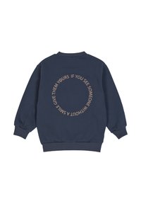 Navy blue sweatshirt with ribbed cuffs and hem, featuring circular beige text on back saying, "If you see someone without a smile give them yours."
