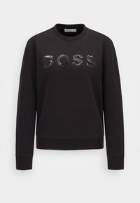 Svart sweatshirt i mjukt tyg med rund halsringning, långa ärmar och paljettbokstäverna "BOSS" på framsidan.