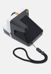 Instant camera with a black body and white accents. Features a square lens, top button, rainbow stripe, and a detachable black strap.