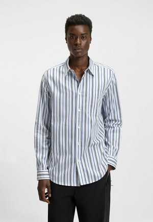 Men's long-sleeve shirt in white with vertical blue stripes. Features a button-down front, a chest pocket, and a relaxed fit.