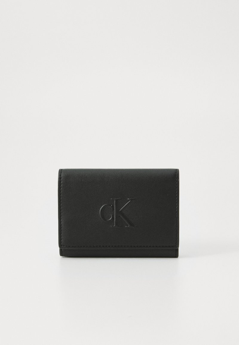 Black leather wallet with a smooth texture, featuring an embossed CK logo on the front, and a compact rectangular shape.