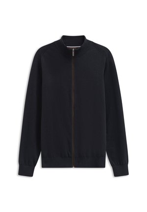 Schwarze Zip-Jacke mit hohem Kragen, gerippten Bündchen und Saum. Glatte Textur und minimalistisches Design. Dezentes braunes Reißverschlus Detail.