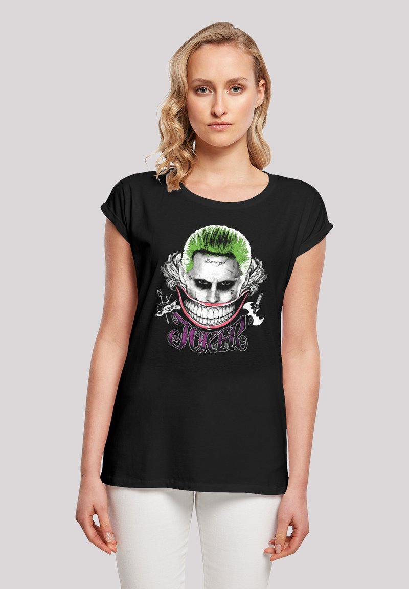 Black t-shirt featuring a graphic design of a character with green hair and a wide grin, surrounded by ornate details and the word "JOKER."
