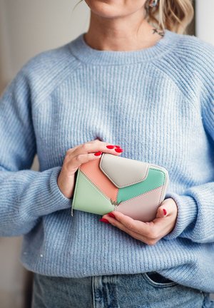 Multicolored wallet with geometric design; features pastel pink, mint green, and beige sections. Smooth leather with zipper closure.