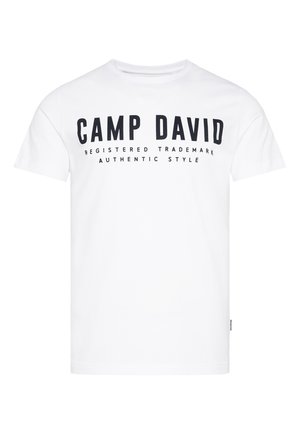 White cotton t-shirt featuring black printed text: "CAMP DAVID," and tagline "REGISTERED TRADEMARK AUTHENTIC STYLE." Classic crew neck design.