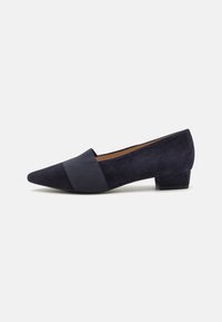 Navy blue suede shoes with a pointed toe, featuring a textured elastic band across the front and a low block heel.