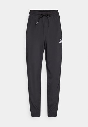 Pantaloni sportivi neri realizzati in materiale leggero, con vita elastica, coulisse e un piccolo logo bianco di lato.