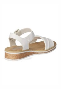 Sandal in pelle bianca con suola in sughero a zeppa, caratterizzata da un design con cinturino e una soletta testurizzata per il comfort. Include cinturino regolabile alla caviglia.