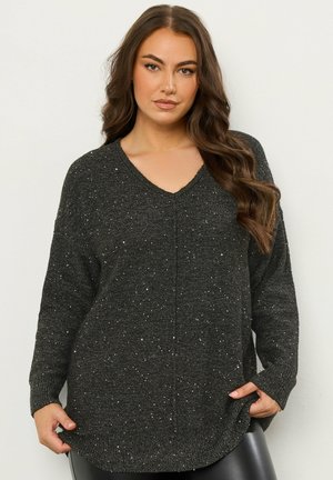 Maglione nero con scollo a V, maniche lunghe e vestibilità ampia; caratterizzato da una texture con puntini argentati su tutta la superficie. Orlo curvo nella parte inferiore.