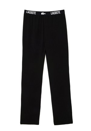 Schwarze Baumwollleggings mit einem elastischen Bund, auf dem das Lacoste-Logo in Weiß abgebildet ist. Das Design ist einfach und hat einen geraden Schnitt.