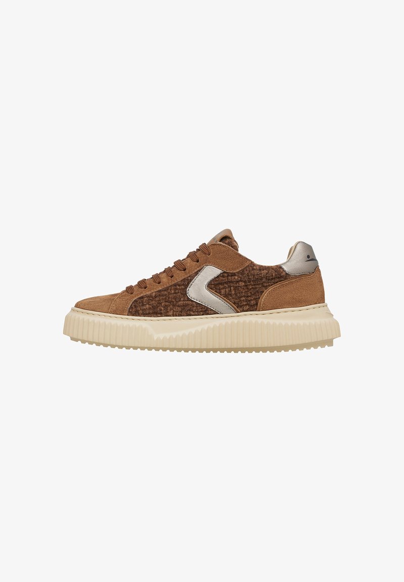 Bruine suède sneaker met een gestructureerd zijpaneel, zilveren accenten en een dikke roomkleurige rubberen zool. Voorzien van bruine veters en een gevoerde kraag.