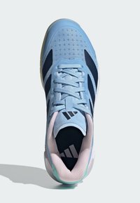 Light blue athletic shoe featuring mesh upper, navy accents, rubber sole, and a padded collar with a textured tongue and logo detail.