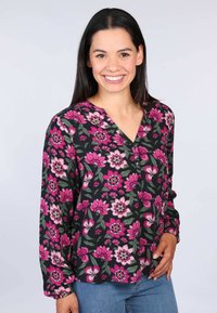Blumenbluse mit schwarzem Hintergrund, die mit rosa und weißen Blumen verziert ist. V-Ausschnitt-Design und lange Ärmel mit elastischen Bündchen.