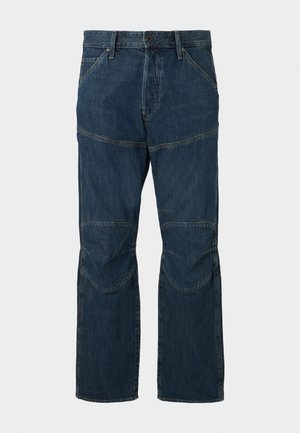 Tmavomodré džíny z denimu s vystuženými kolenami, predným zapínaním na gombík a zips a prednými vreckami na jednoduchom pozadí.