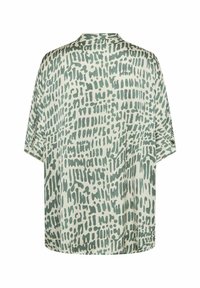Blouse ample couleur crème clair avec un motif abstrait vert. Dotée d'un col et de manches courtes, réalisée en tissu doux et léger.