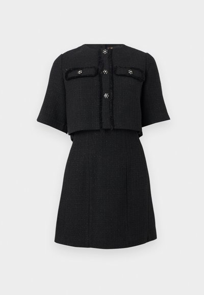 Μαύρο κοντό σακάκι με υφή, μανίκια μέχρι τον αγκώνα και διακοσμητικά κουμπιά με κρύσταλλα, σετ με ψηλόμεση φούστα γραμμής Α σε ίδιο ύφασμα.