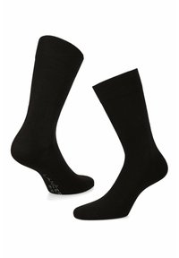 Czarne skarpetki bawełniane z żebrowanym mankietem i bezszwowym palcem. Posiadają miękką fakturę oraz klasyczny krój do kostki. Logo nadrukowane na podeszwie.