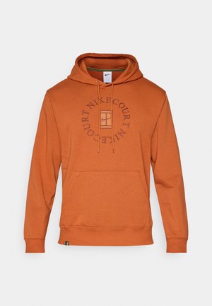 Orange hoodie made of cotton blend, featuring a front pouch pocket, drawstrings, and circular "Nike Court" logo in navy on the chest.