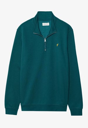 Teal zip-up sweatshirt with a stand collar. Features a gold logo accent on the chest and ribbed cuffs and hem. Soft fabric texture.